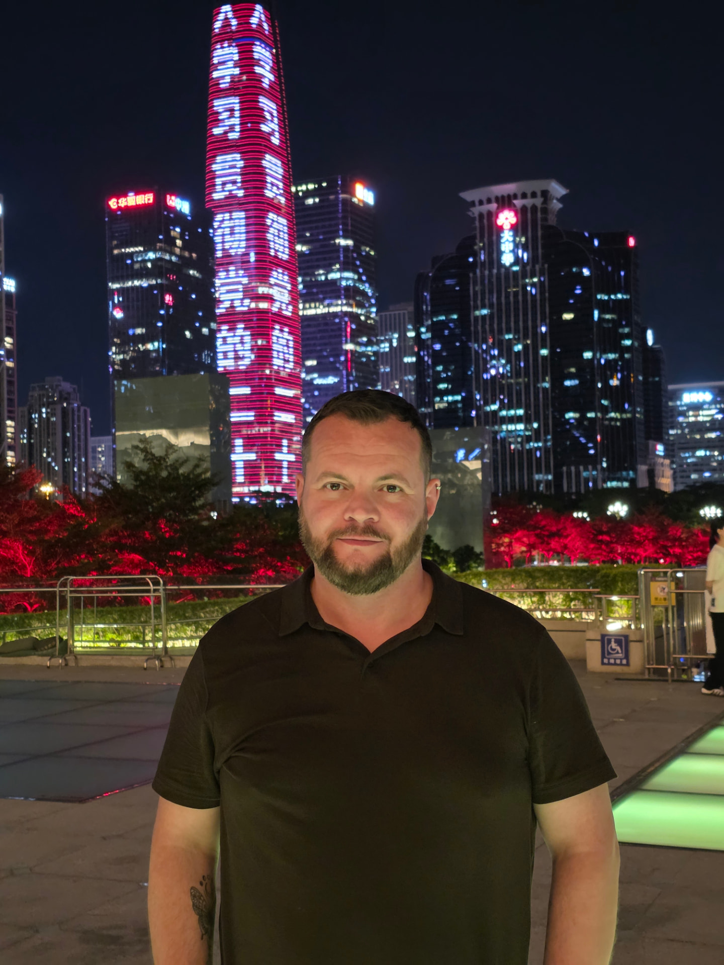 Bartek, founder of withbartek.com, photographed in front of a city skyline at night